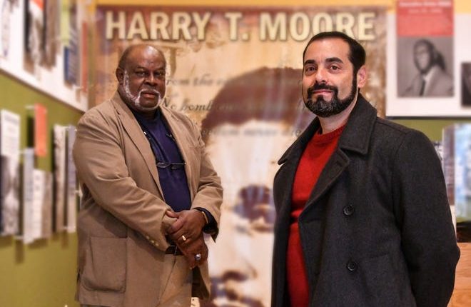 Anthony Colucci (right), president of the Brevard Federation of Teachers, and William Gary (left), president of the Harry T. and Harriette V. Moore Cultural Complex, in the museum at the Moore Cultural Complex in Mims.  The two groups have asked the Brevard County School Board to posthumously reinstate Harry and Harriette Moore as teachers and to include the Moores' history in the Brevard curriculum.
