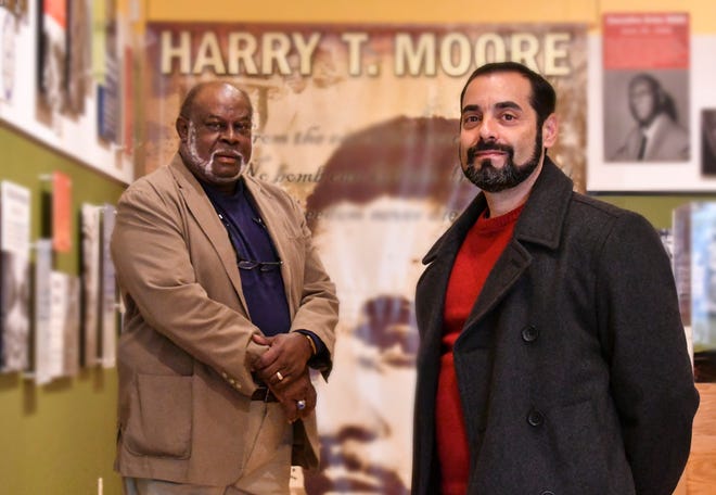 Anthony Colucci (right), president of the Brevard Federation of Teachers, and William Gary (left), president of the Harry T. and Harriette V. Moore Cultural Complex, in the museum at the Moore Cultural Complex in Mims.  The two groups have asked the Brevard County School Board to posthumously reinstate Harry and Harriette Moore as teachers and to include the Moores' history in the Brevard curriculum.