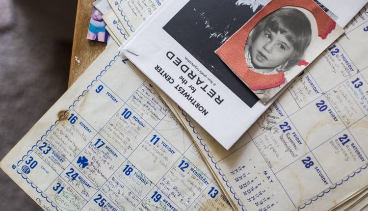 A photograph of Janet Taggarts daughter, Naida, sits on top of her old calendars filled with appointments and notes in her home. (Olivia Vanni / The Herald)