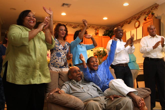 Marcus Garvey Jr., son of the late civil rights activist Marcus Garvey (seated in the chair), watches the return of the election with family and friends on November 4, 2008 in Wellington when Barack Obama became the first black President of the United States.  Garvey Jr. died in Wellington on December 8th after a long battle with Alzheimer's disease.