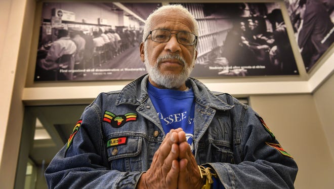 Former Alderman Kwame Leo Lillard stands in front of photos of 1960s Nashville civil rights protests in the Nashville Public Library on Wednesday, January 10, 2018.  A civil rights activist in Nashville for most of his life, 78-year-old Lillard witnessed and witnessed many beatings, burns, curses and racist epithets during the 1960 sit-ins he helped organize.