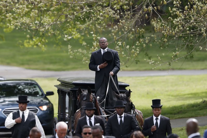 FILE - This Saturday April 4, 2020, the coffin of Rev. Joseph E. Lowery, horse and carriage, is being carried to the grave in Westview Cemetery in Atlanta.  More than four decades after the death of his friend and civil rights icon, Rev. Martin Luther King Jr., the fiery Alabama preacher Lowery was at the forefront of the battle for equality, with an unforgettable performance that often rivaled King's more unpredictable.  (AP Photo / John Bazemore, Pool, File)