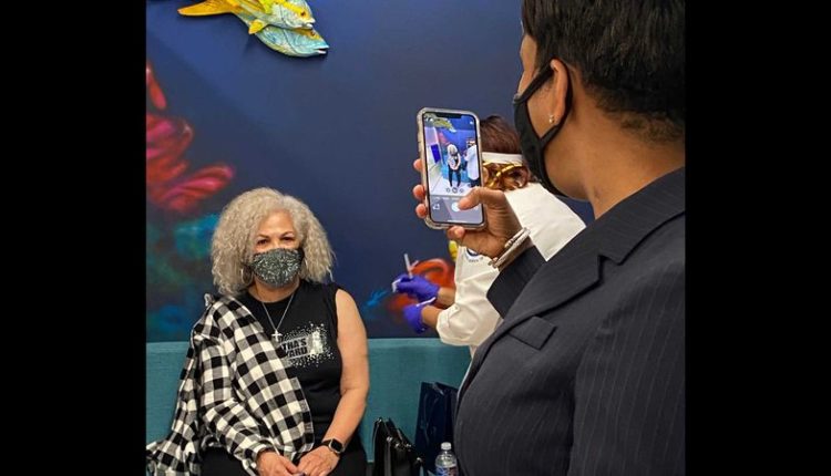 ATLANTA - Atlanta Mayor Keisha Lance Bottoms takes a picture of her mother Sylvia Robinson receiving a vaccine for Moderna COVID-19 at Morehouse School of Medicine on January 5, 2021.  ERIC STIRGUS/ESTIRGUS@AJC.COM.