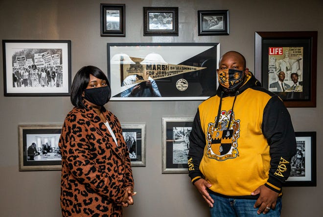 Aaron Pearl-Cropp and his wife Annie Brooks-Pearl pose with only some of the Martin Luther King Jr. and Civil Rights Movement memorabilia on display in their home, including an original pennant and button dated March 1963 in Washington, Thursday, March 14th January 2021 in Illinois, Pearl-Cropp became interested in memorabilia collecting three years ago after starting an internship at the Central Illinois African American History Museum as part of his master's degree. [Justin L. Fowler/The State Journal-Register]