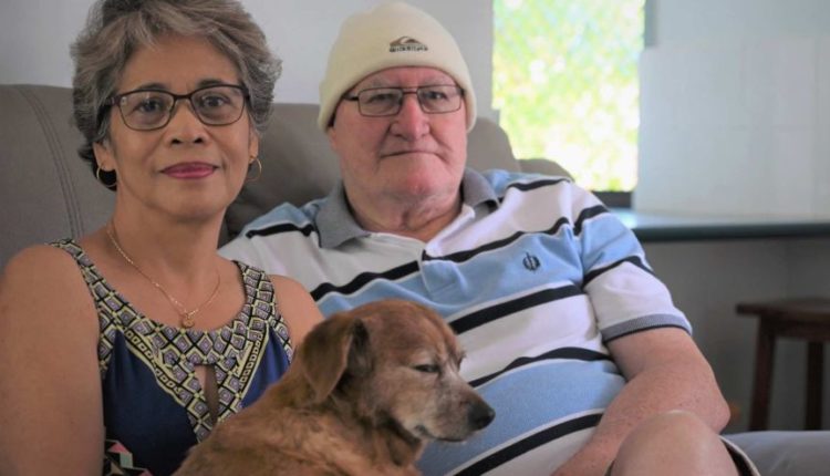 Woman, man and dog on a couch