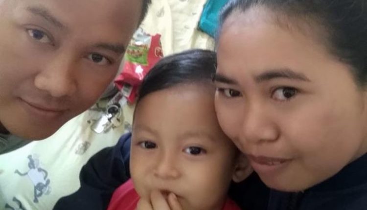 Asian father with his son in the middle and his wife on the right.