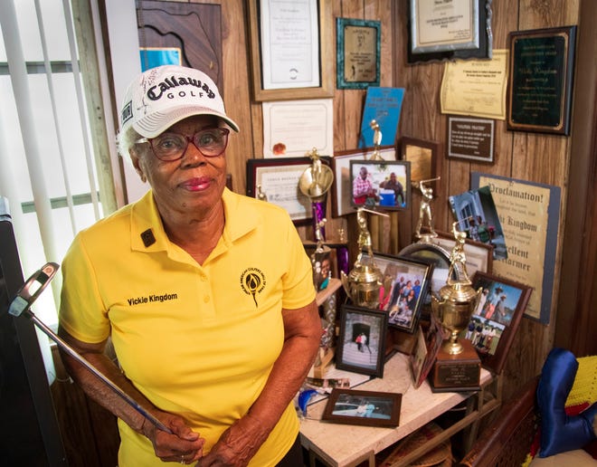 Victoria Kingdom, 92, poses with some of the many golf prizes and trophies she has at her Riviera Beach home.