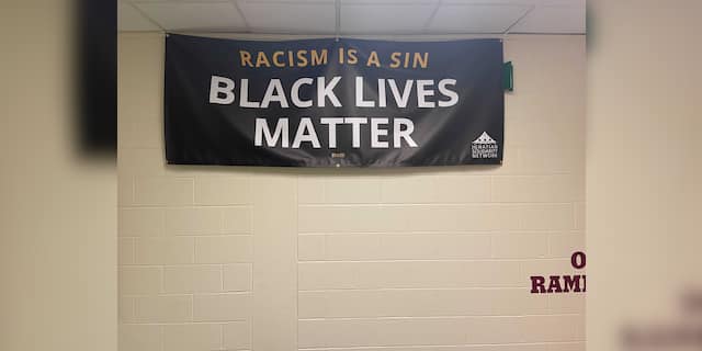 A Black Lives Matter banner hanging in a Loyola Academy hallway.