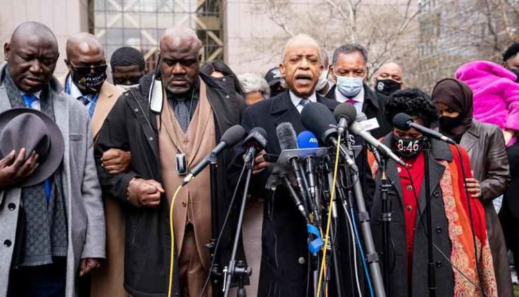 Rev. Al Sharpton, center right, leads a prayer alongside Rodney Floyd, brother of George Floyd, center left, during a news conference outside the Hennepin County Government Center before the murder trial against the former Minneapolis police officer Derek Chauvin in the killing of George Floyd advances to jury deliberations, Monday, April 19, 2021, in Minneapolis.