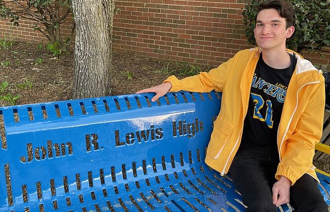 New poet and graduate Charles Childers paid tribute to civil rights leader John R. Lewis, who paid tribute to Lewis at the high school's dedication ceremony.