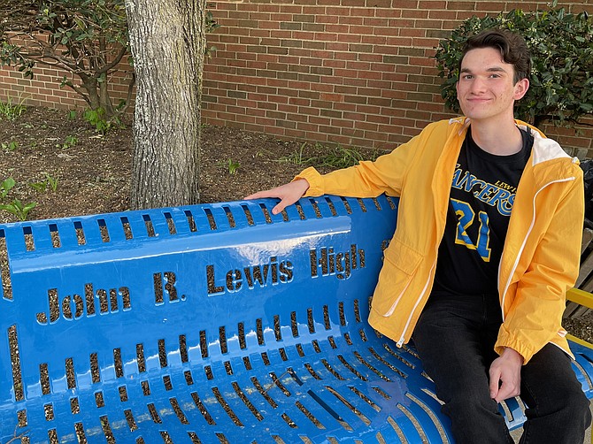 New poet and graduate Charles Childers paid tribute to civil rights leader John R. Lewis, who paid tribute to Lewis at the high school's dedication ceremony.