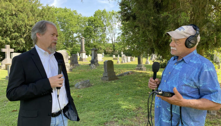 Historian Eric Jacobson (left) talks with correspondent Tom Wilmer in the graveyard of the antebellum St. Peter's Episcopal Church on the outskirts of Mt. Pleasant, Tennessee