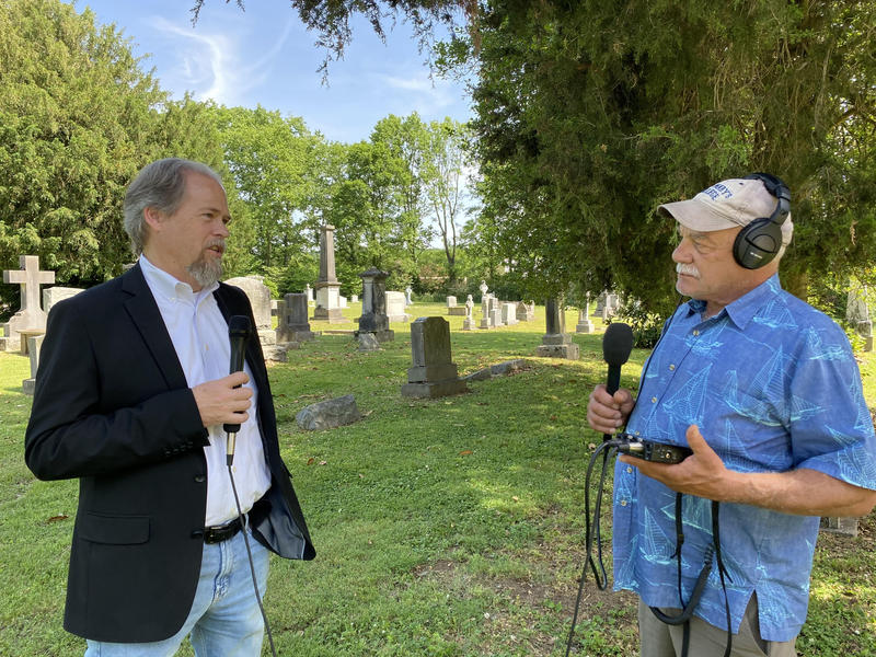 Historian Eric Jacobson (left) talks with correspondent Tom Wilmer in the graveyard of the antebellum St. Peter's Episcopal Church on the outskirts of Mt. Pleasant, Tennessee