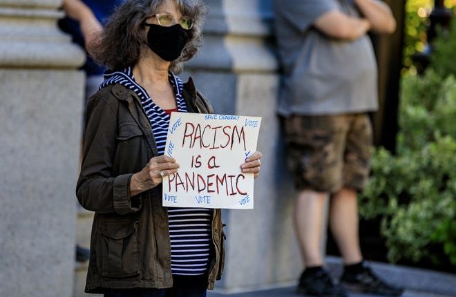 A protester holds a sign that reads 