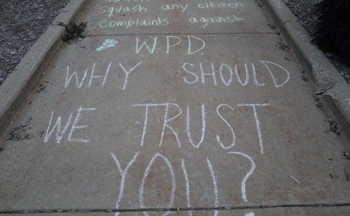 Protesters marked the ground in front of Wauwatosa City Hall with chalk with various messages written on it.  (Photo | Isiah Holmes)