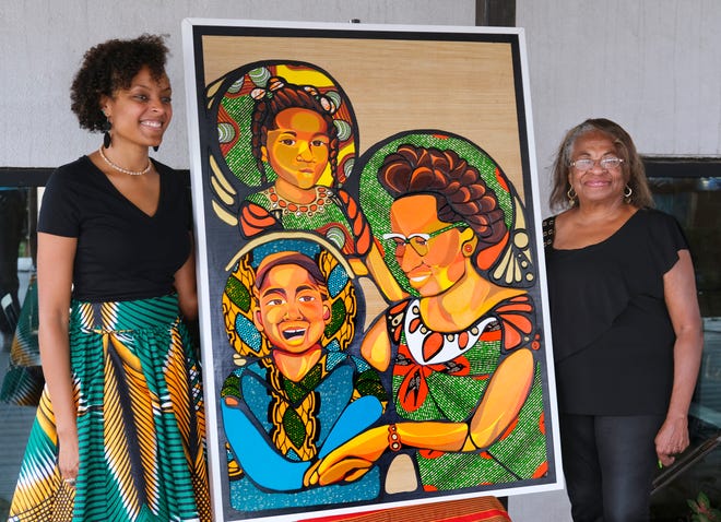 Artist Ebony Iman Dallas (left) and Marilyn Luper Hildreth, Clara Luper's daughter, pose next to a Luper of Dallas multimedia artwork commissioned by Citizen's Bank of Edmond during a unveiling Thursday morning.